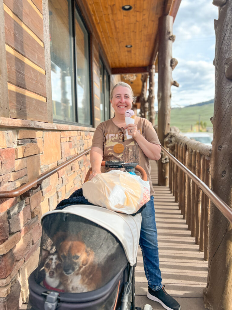 Melissa eating an ice cream cone from Yellowstone Gifts and Sweets. Her dog is in a stroller.