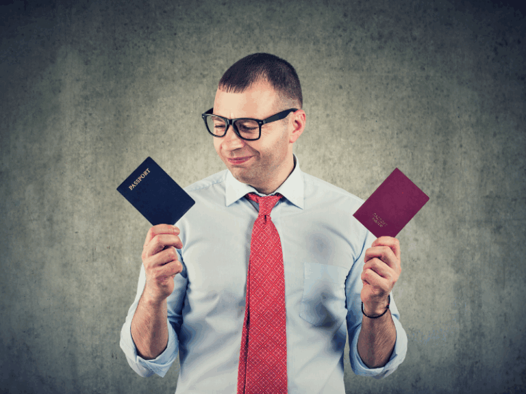 Man looking at 2 passports