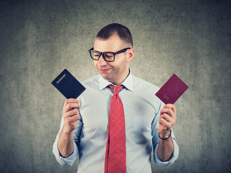 Man looking at 2 passports