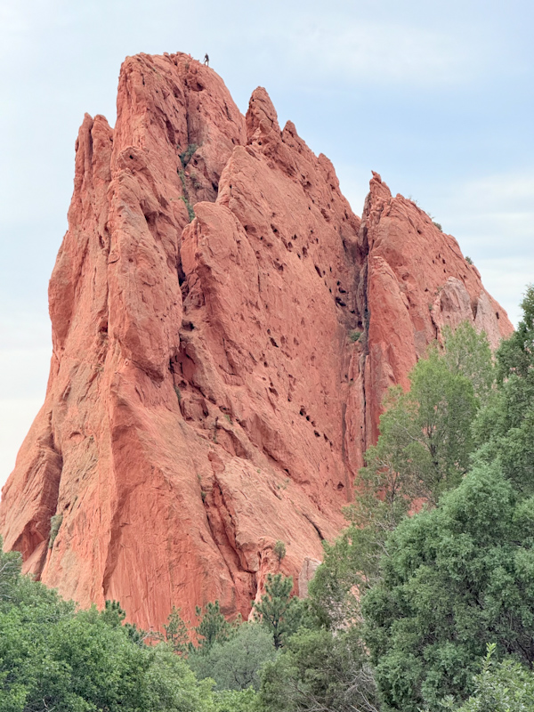 Garden of the Gods blue rock with man on top-1