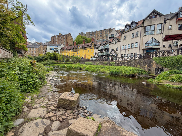 This photograph captures the scenic Dean Village in Edinburgh, Scotland, situated alongside the Water of Leith