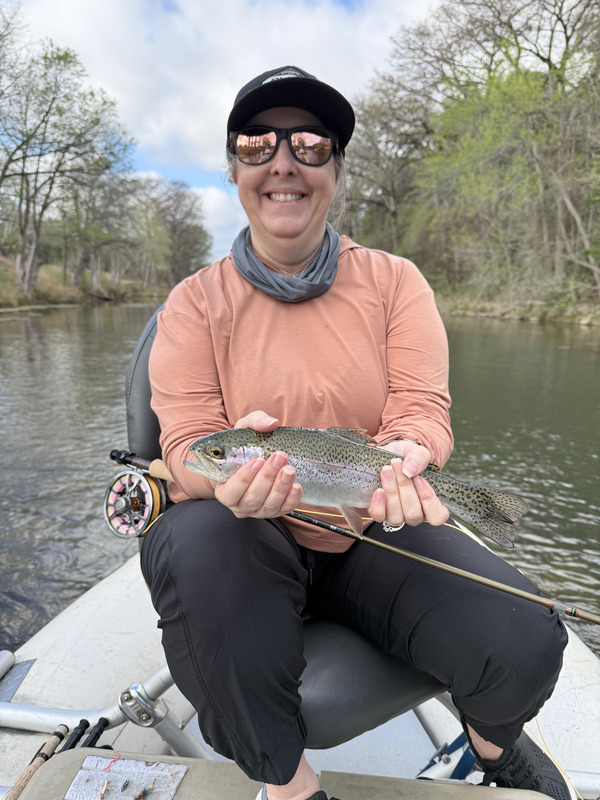 Melissa in the boat with one of the fish she caught