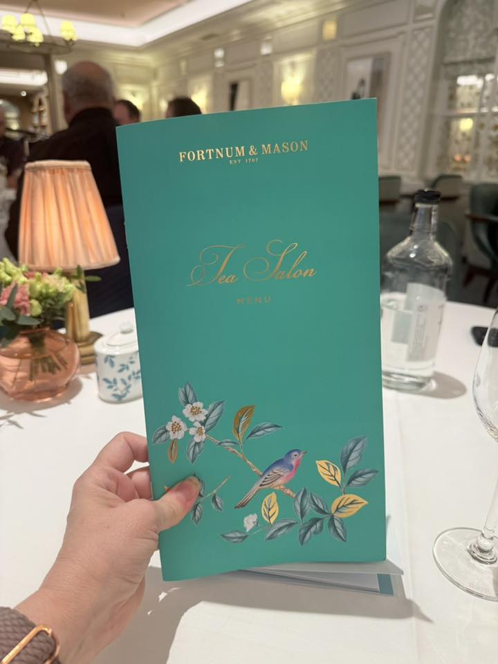 Fortnum & Mason afternoon tea Melissa holding a menu
