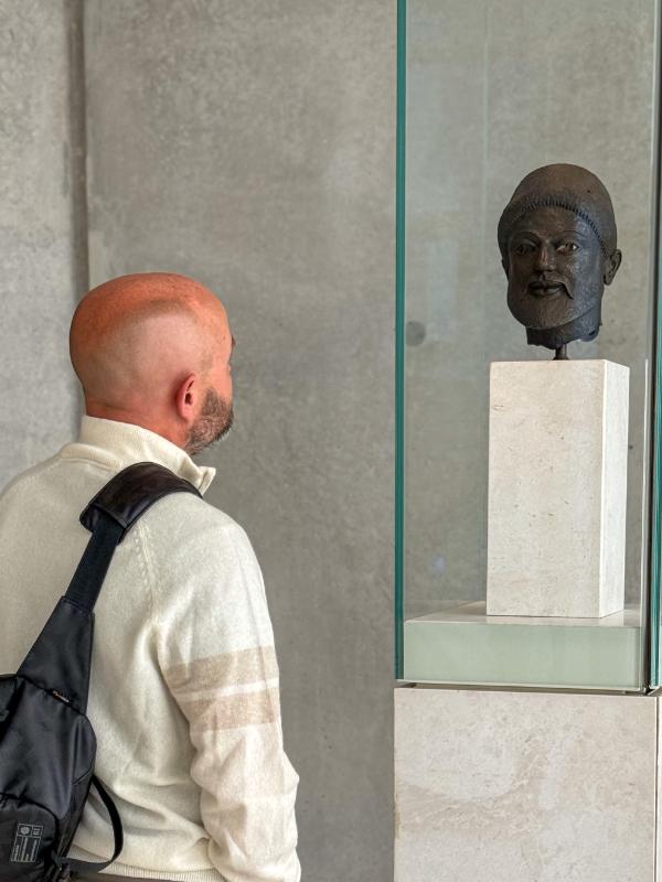 Daniel looking at bust  in museum in Athens